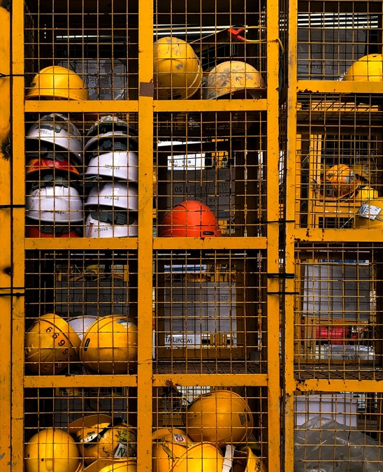 Construction hard hats in a locker - HeightPM